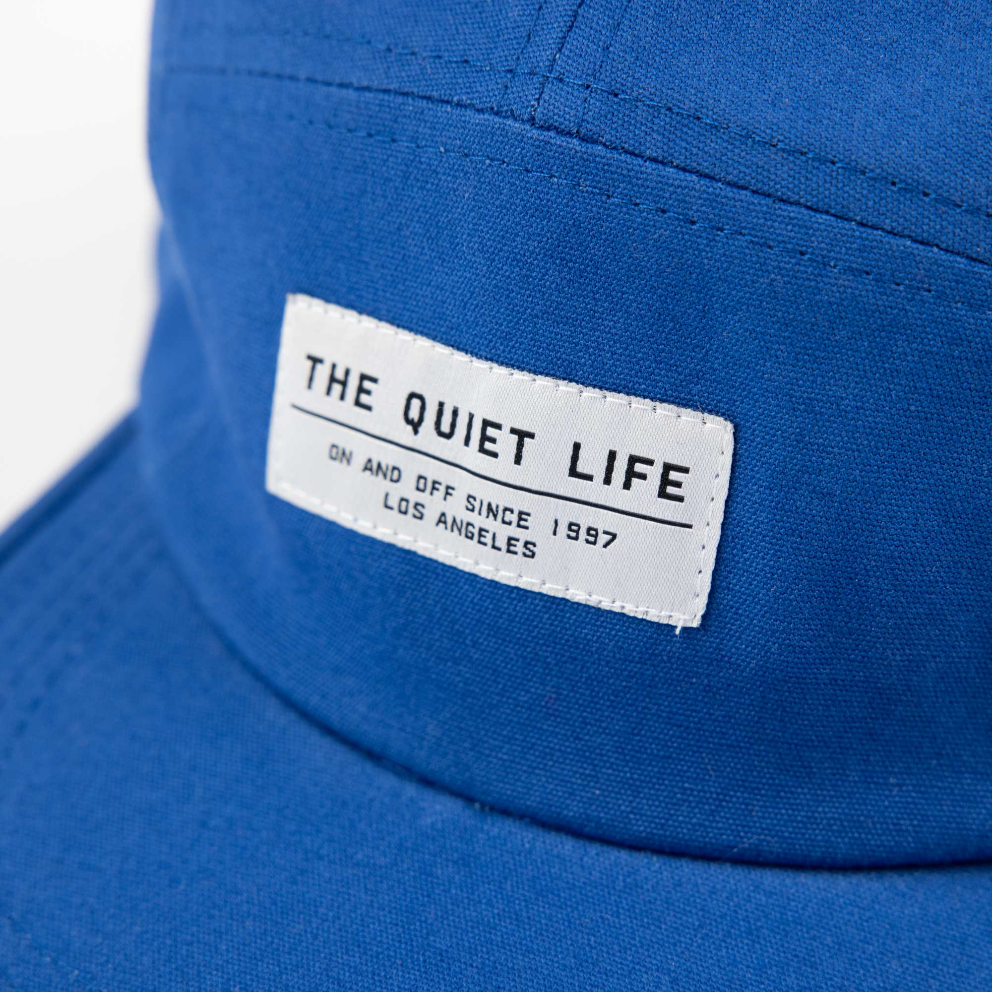 Quiet Life Photographer 5 panel hat, blue — available at Norwood