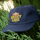 The Quiet Life Everyday Bouquet Polo Hat, navy — available at Norwood