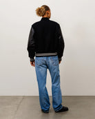 Stussy Wool Varsity, black — available at Norwood