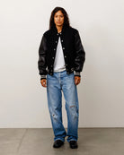 Stussy Wool Varsity, black — available at Norwood